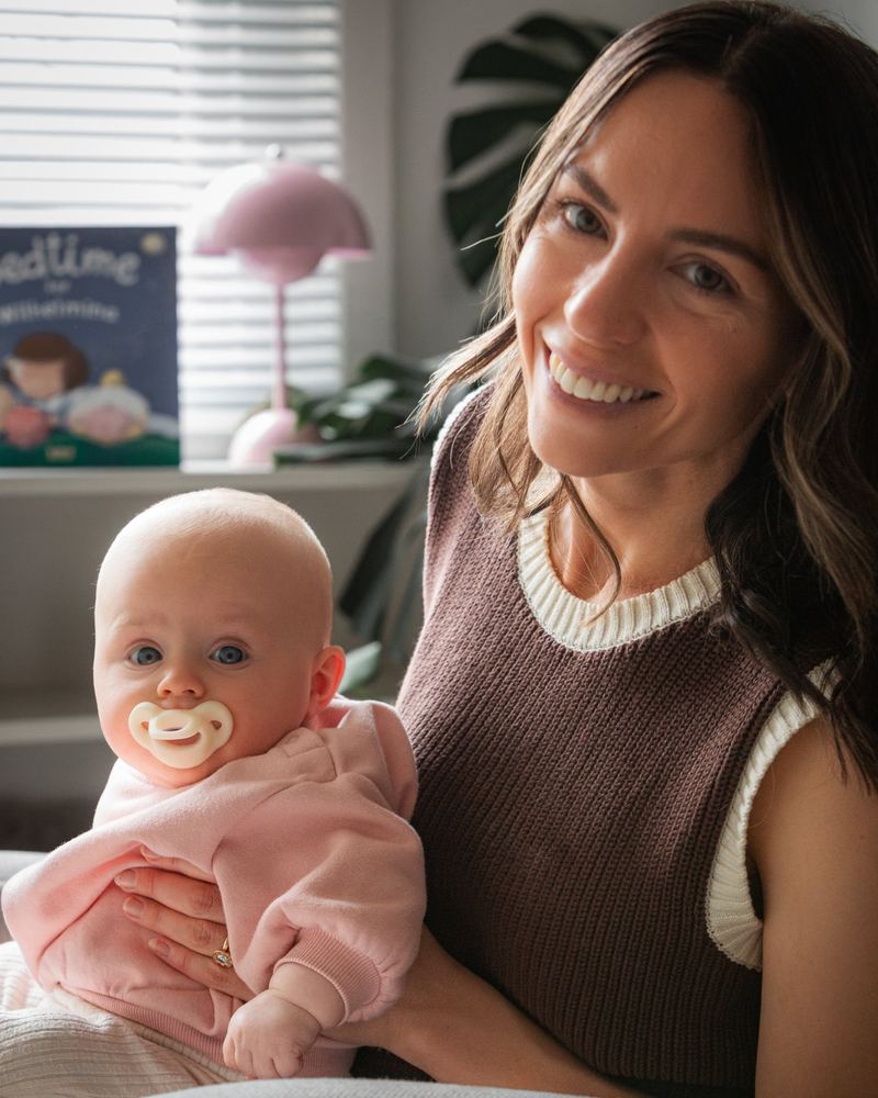 A smiling mum with her baby and a Milk Minbie dummy